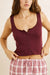 Rhythm Juliet Tank in Plum — Front view, hands adjusting waistband