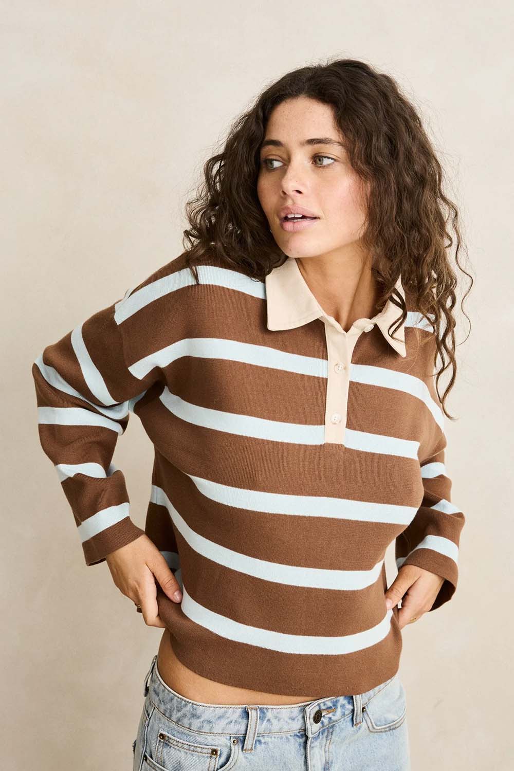 Rhythm Rugby Polo Knit Sweater in Brown — Front view, hands on hips