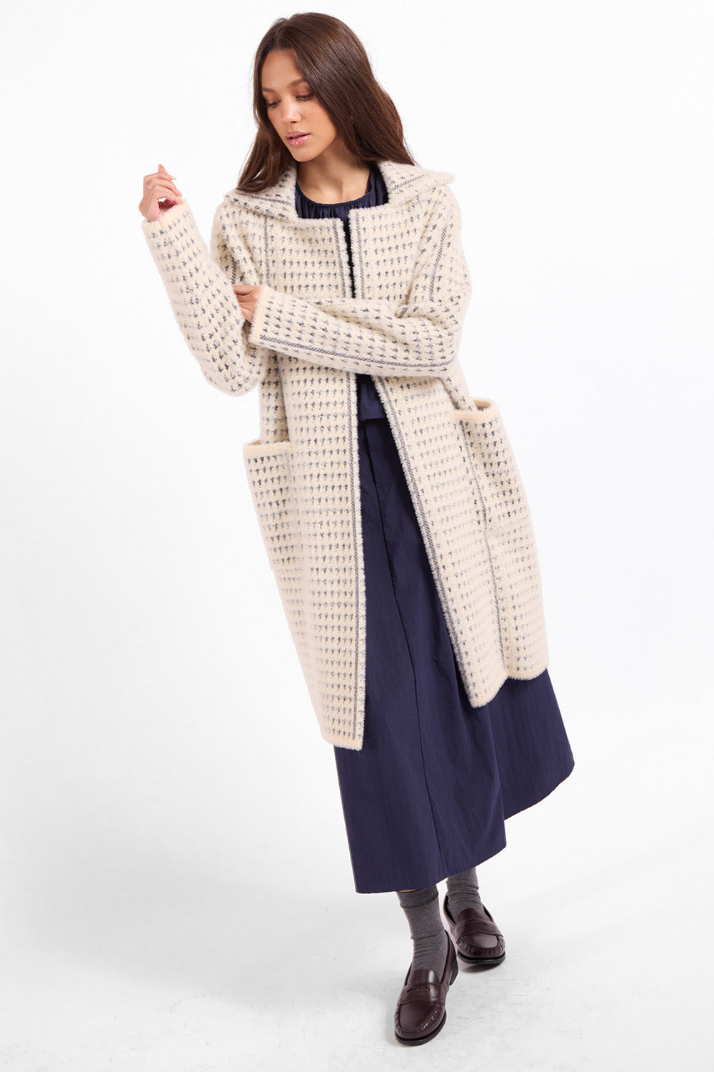 Sage the Label Marceau Houndstooth Coat in Ivory Slate — Quarter view, hand at collar