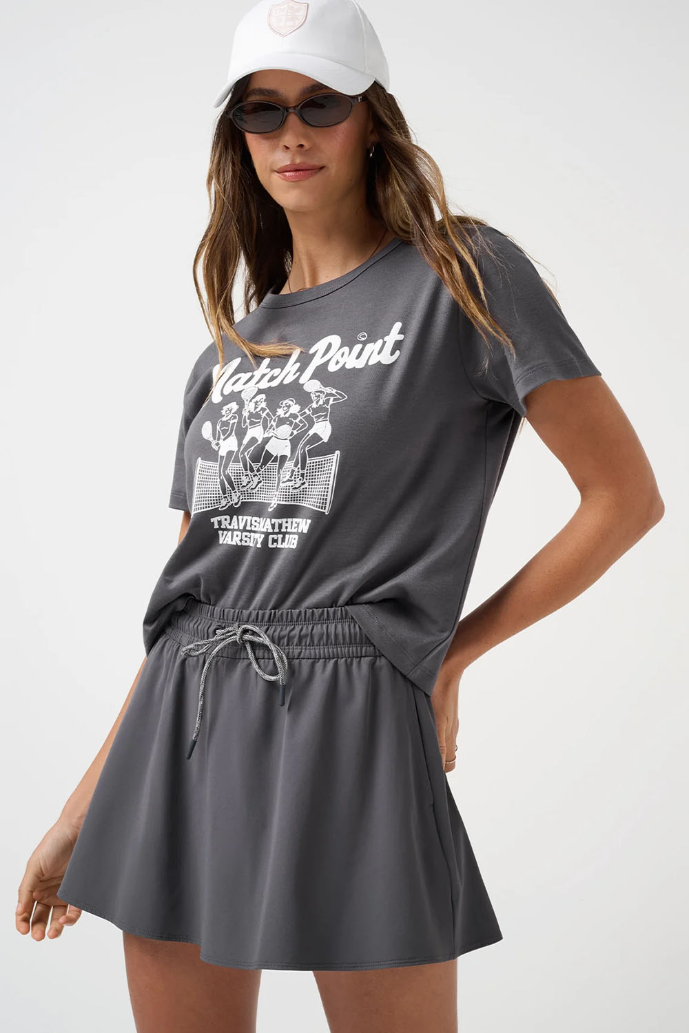 Travis Mathew Relaxed Boxy Tee in Blackened Pearl — Front view, styled with cap and sunglasses