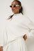 Travis Mathew Skyloft Soft Funnel Neck in Snow White — Full-body view