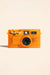 camp-snap-camera-2-tangerine-drift-front
